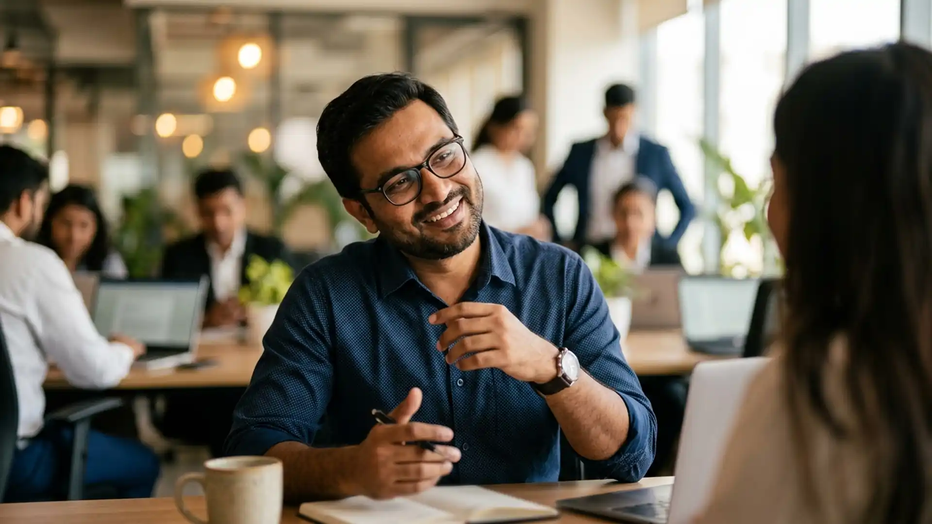 Indian professional performing the head wobble gesture during a business conversation in India