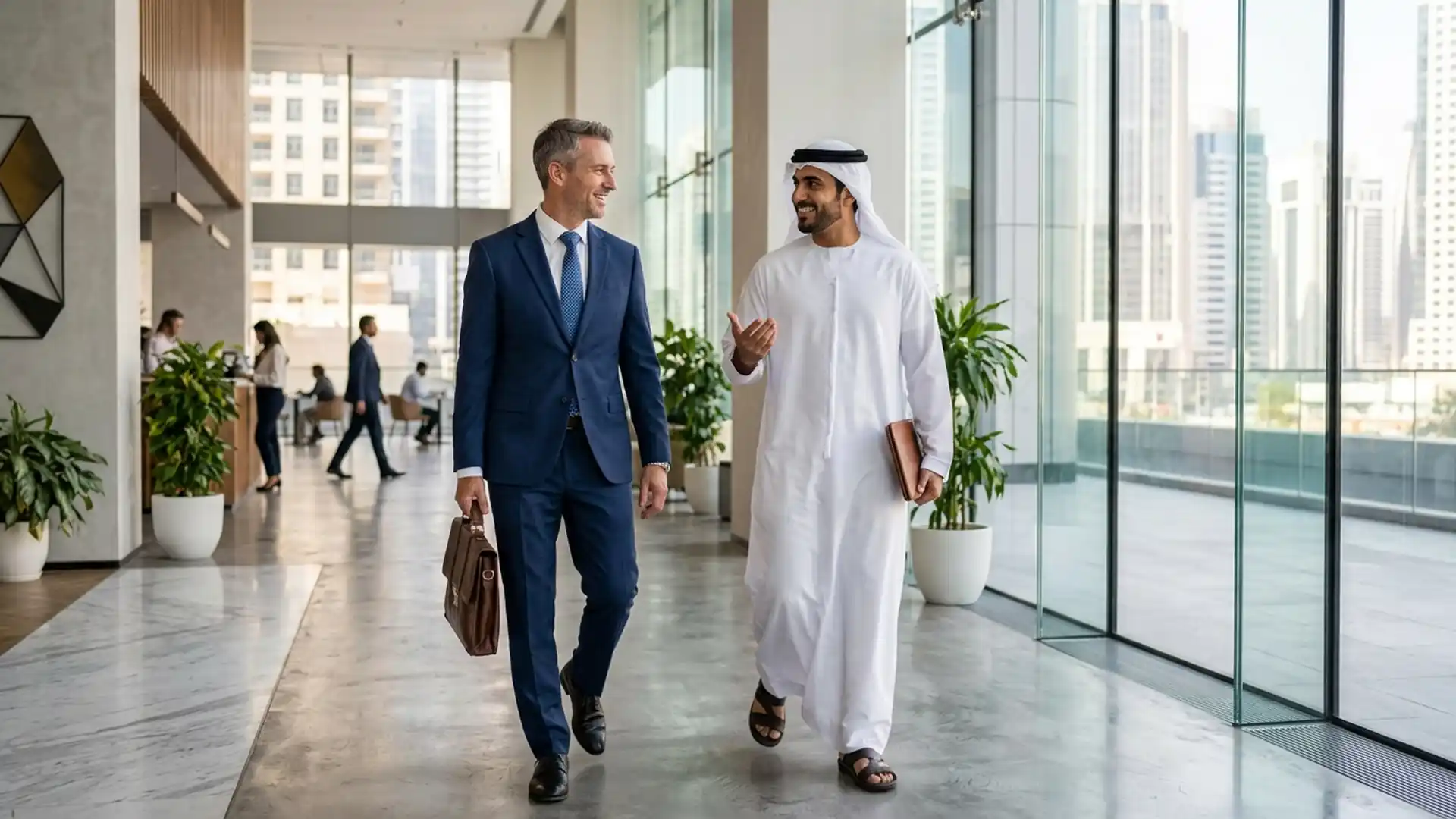 An Emirati man in a kandura and a Western businessman in a suit talking while walking together after a meeting